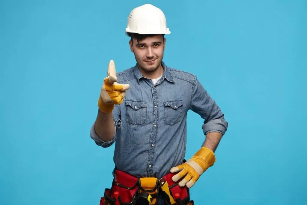 Confident handyman pointing