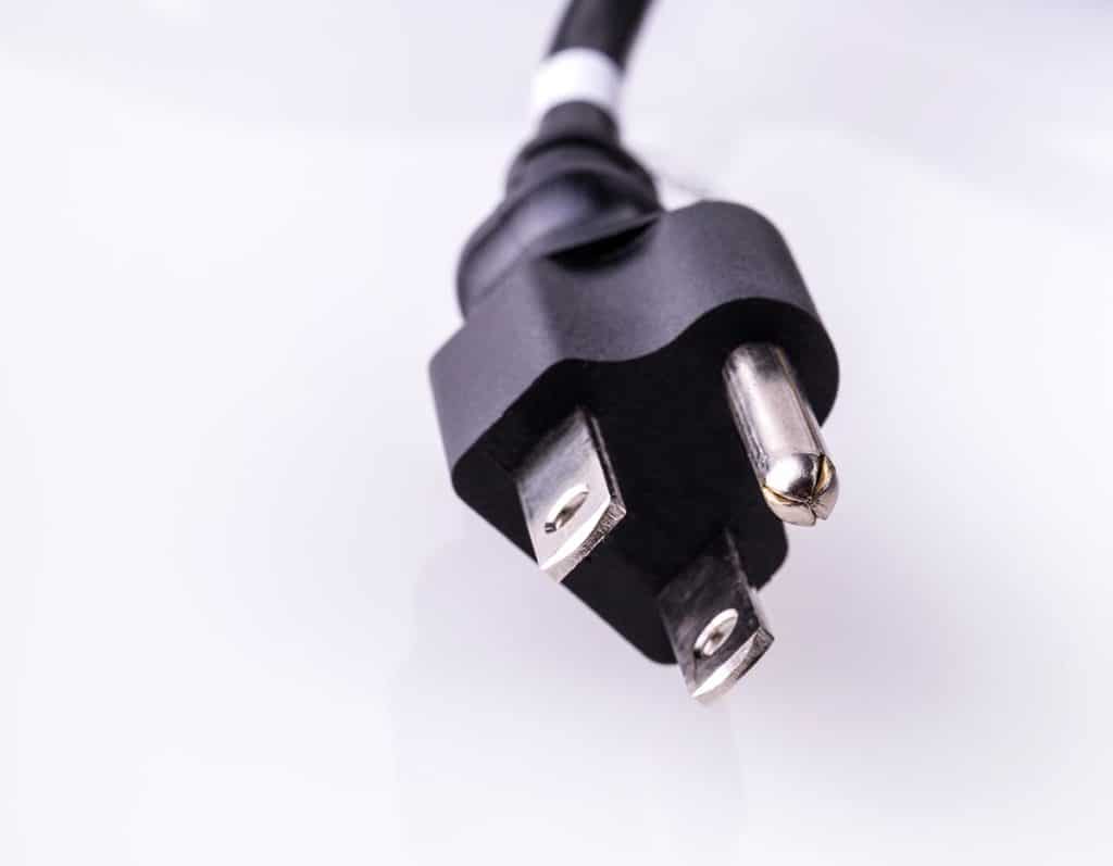 Close-up view of a three-prong electrical plug.