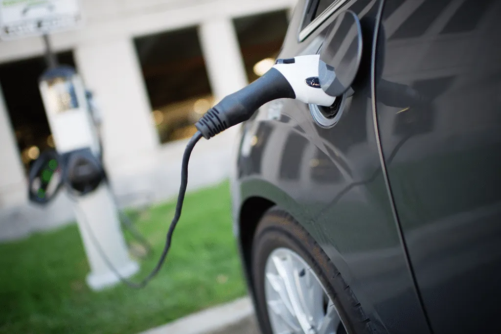 Electric vehicle plugged in at a charging station.